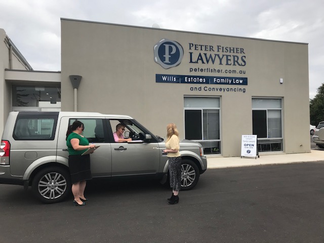 Brighton lawyers and client for document signing outside the law firm in South Adelaide